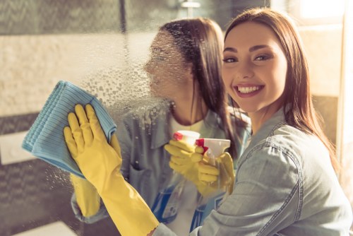 Professional cleaner sanitising an office desk in Edgware